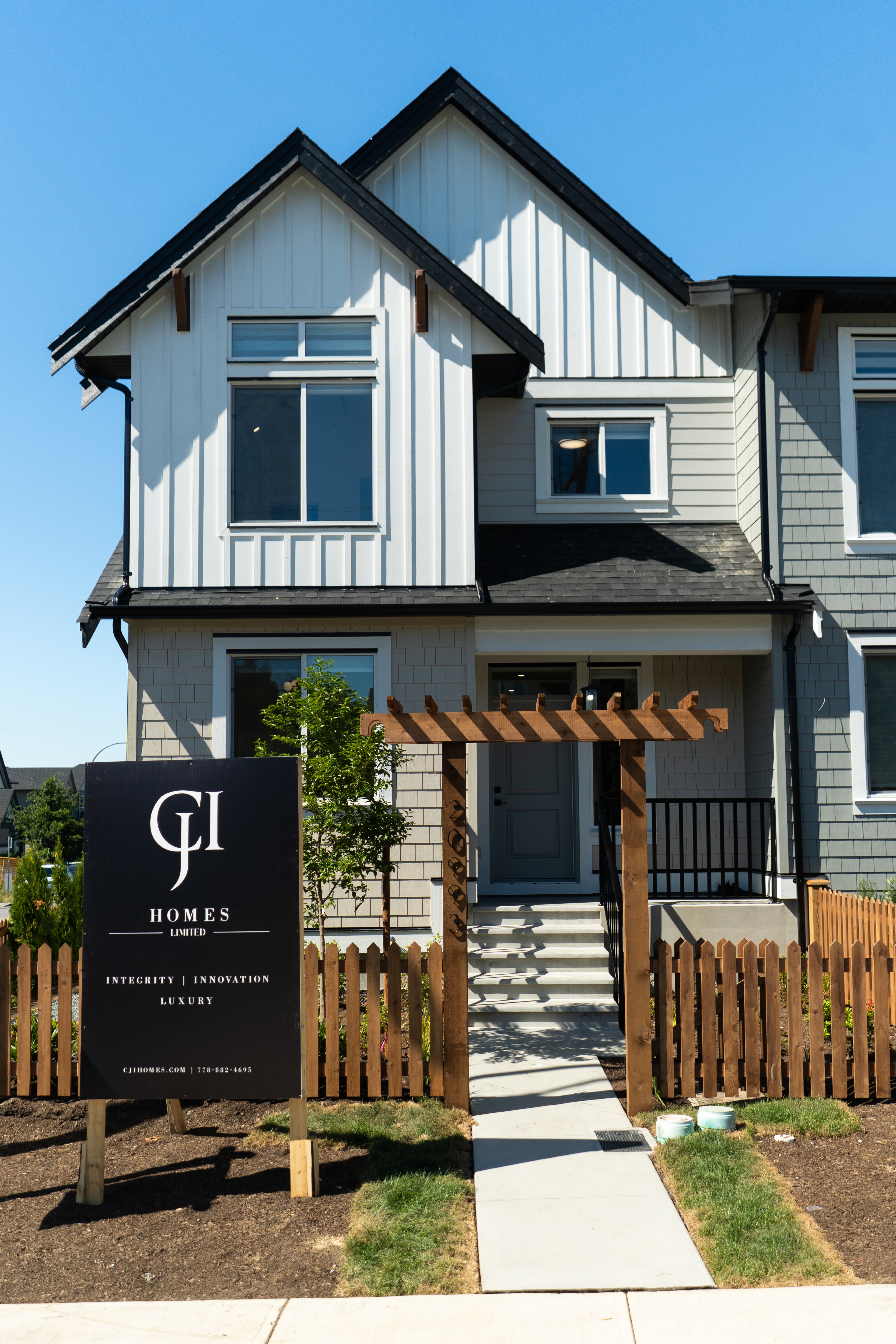 CJI Homes signage at the entry of a completed Willoughby Row home