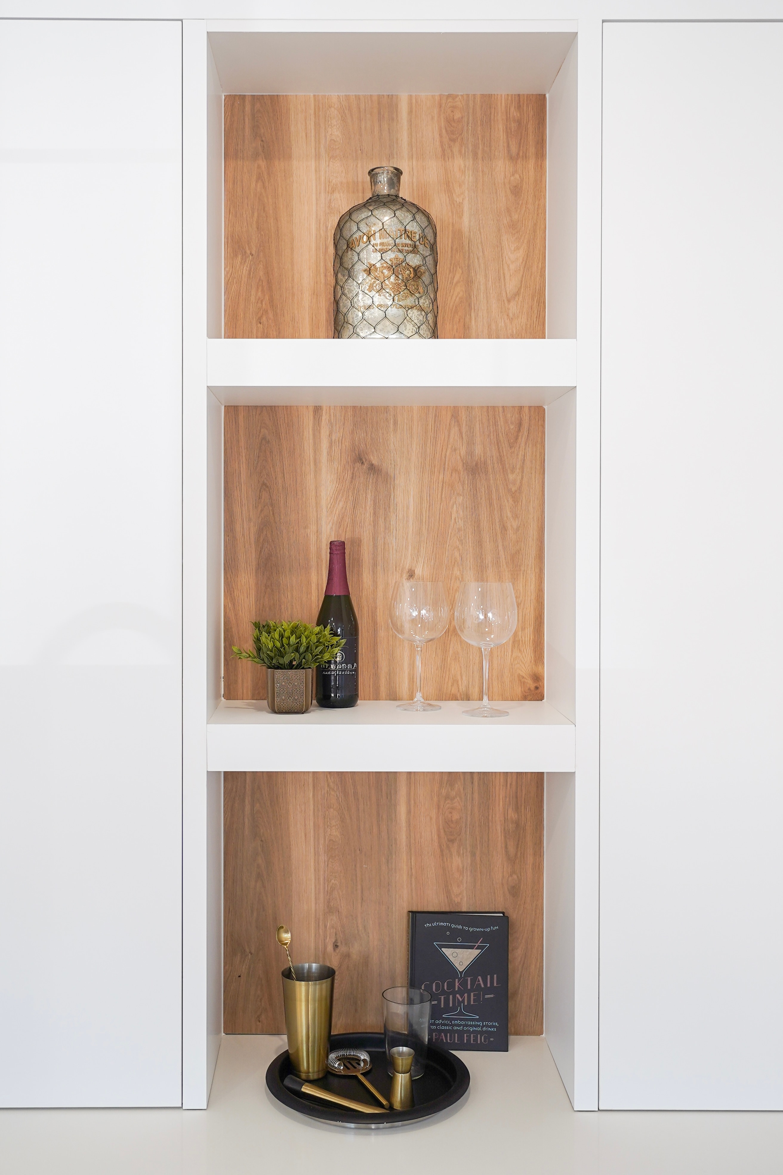 Built-in wine and bar nook with open wood shelving at Willoughby Row