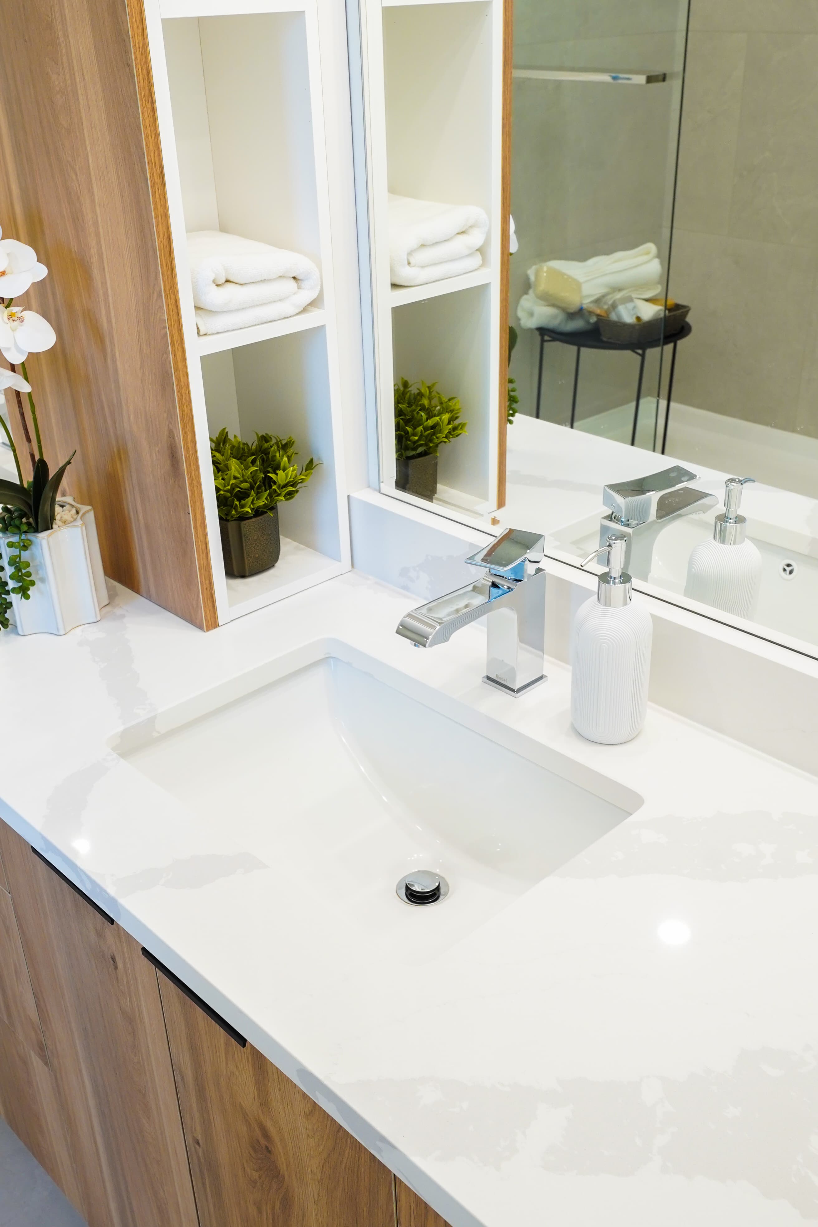 Built-in linen niche and walk-in shower reflection in a Willoughby Row bathroom