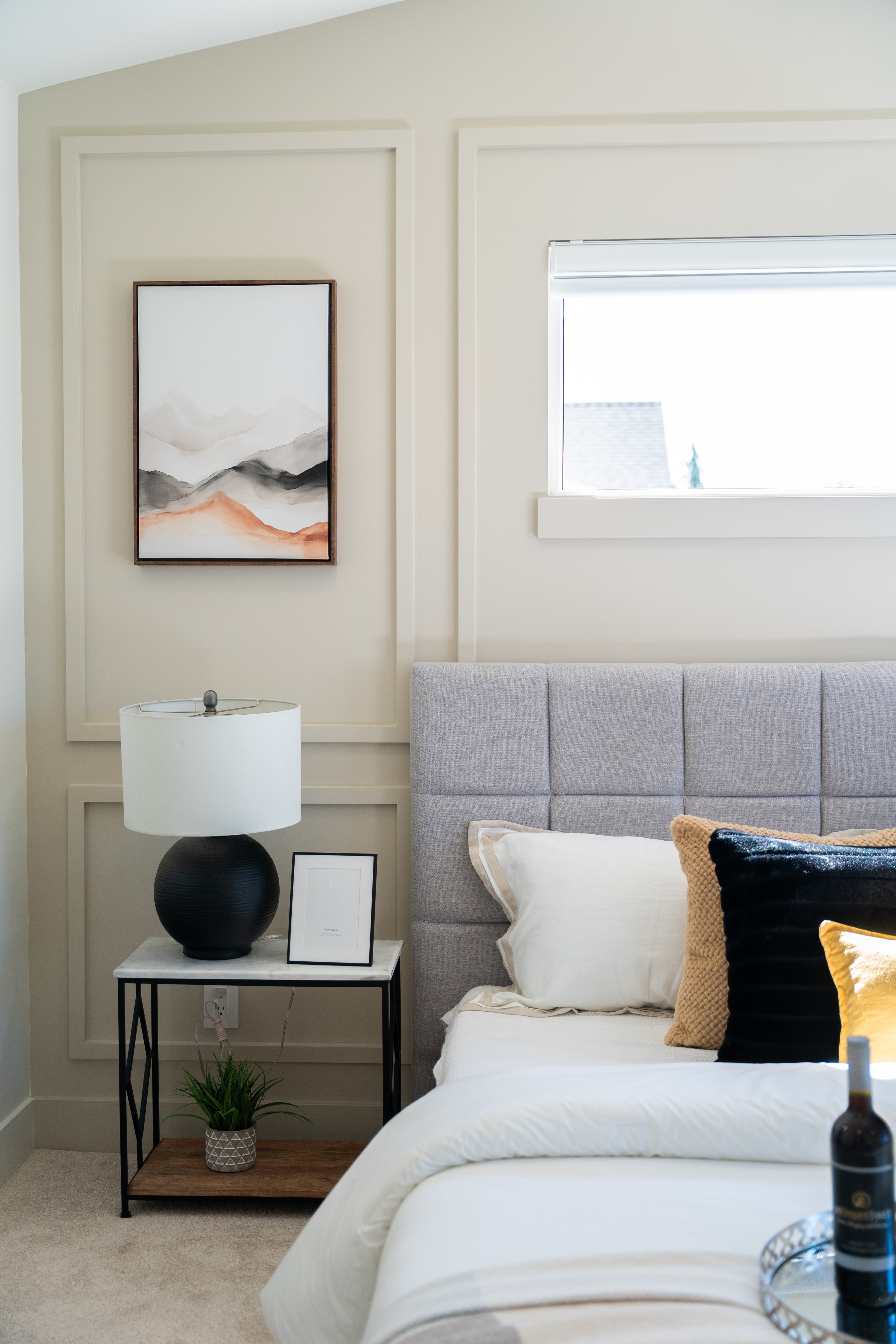 Nightstand and framed artwork detail in the primary bedroom at Willoughby Row