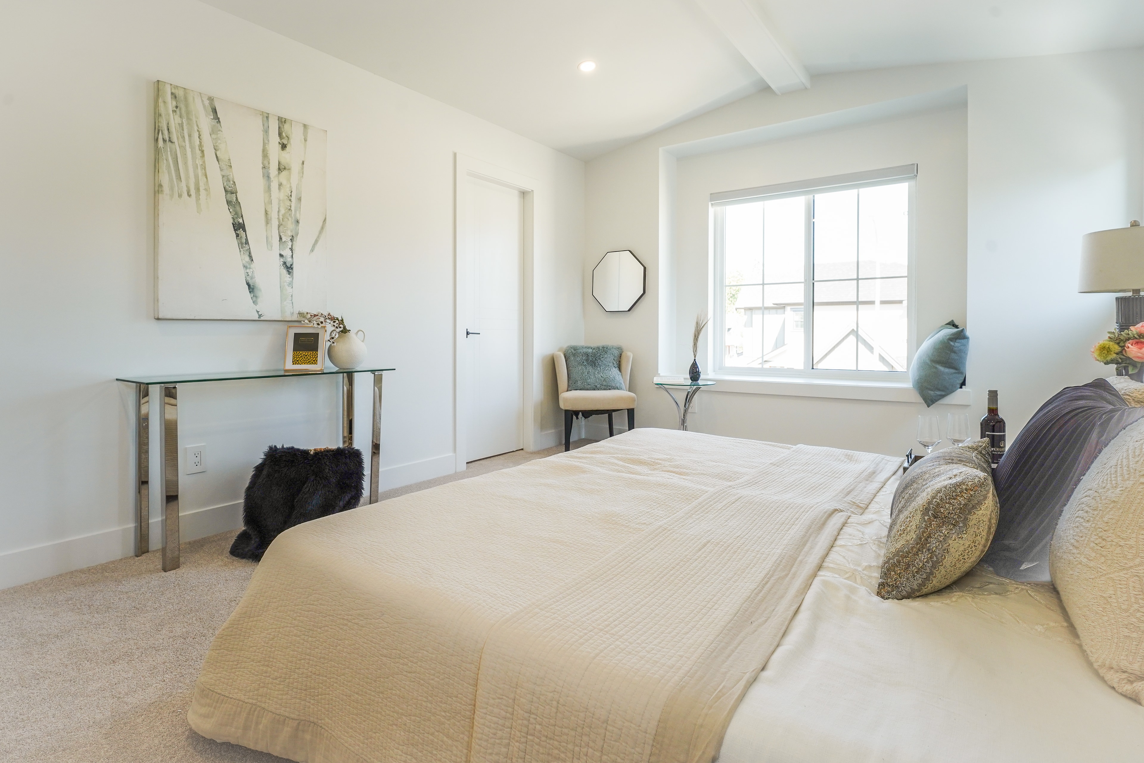 Primary bedroom at Willoughby Row with window seat and octagonal mirror