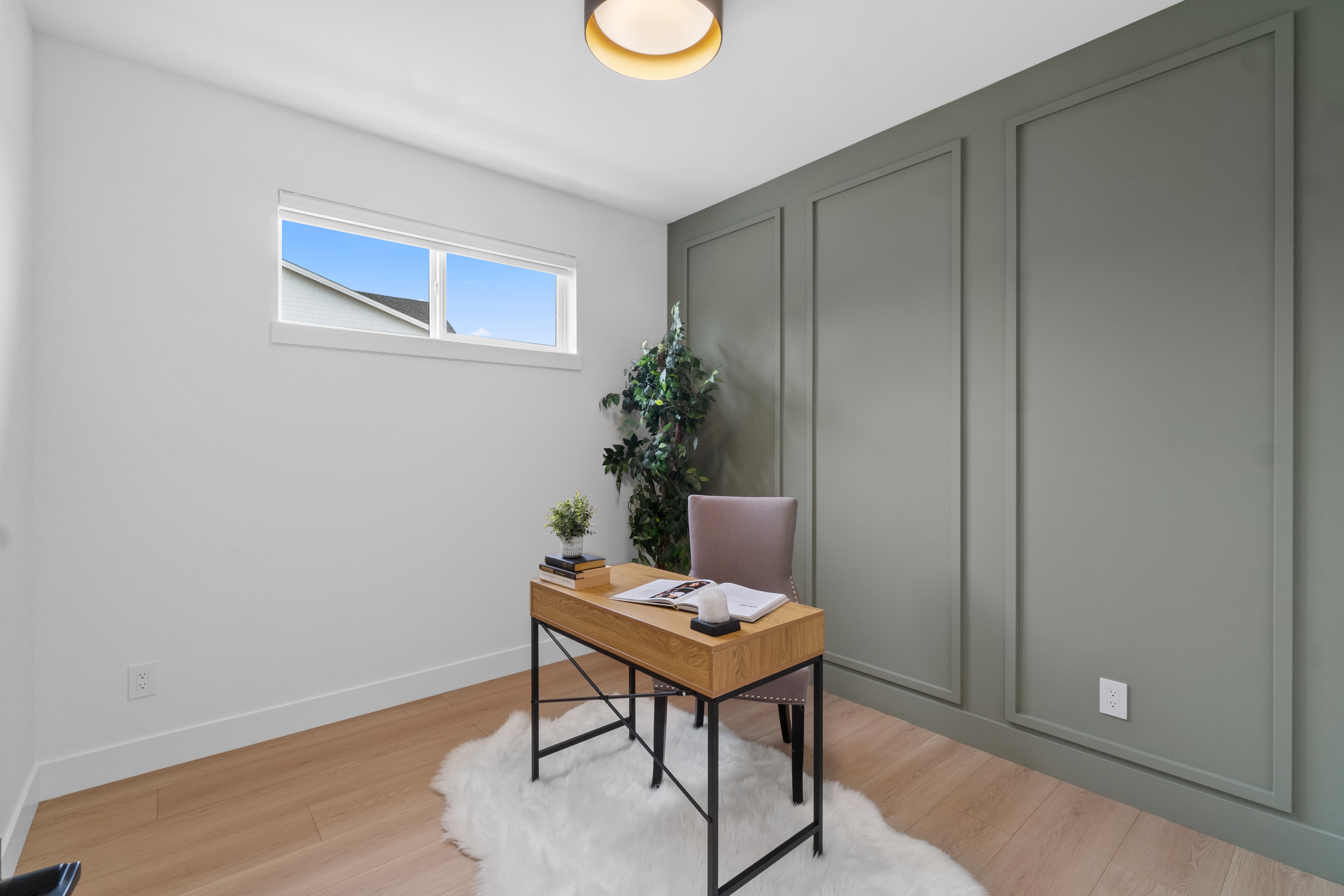 Home office space at Willoughby Row with green panelled accent wall