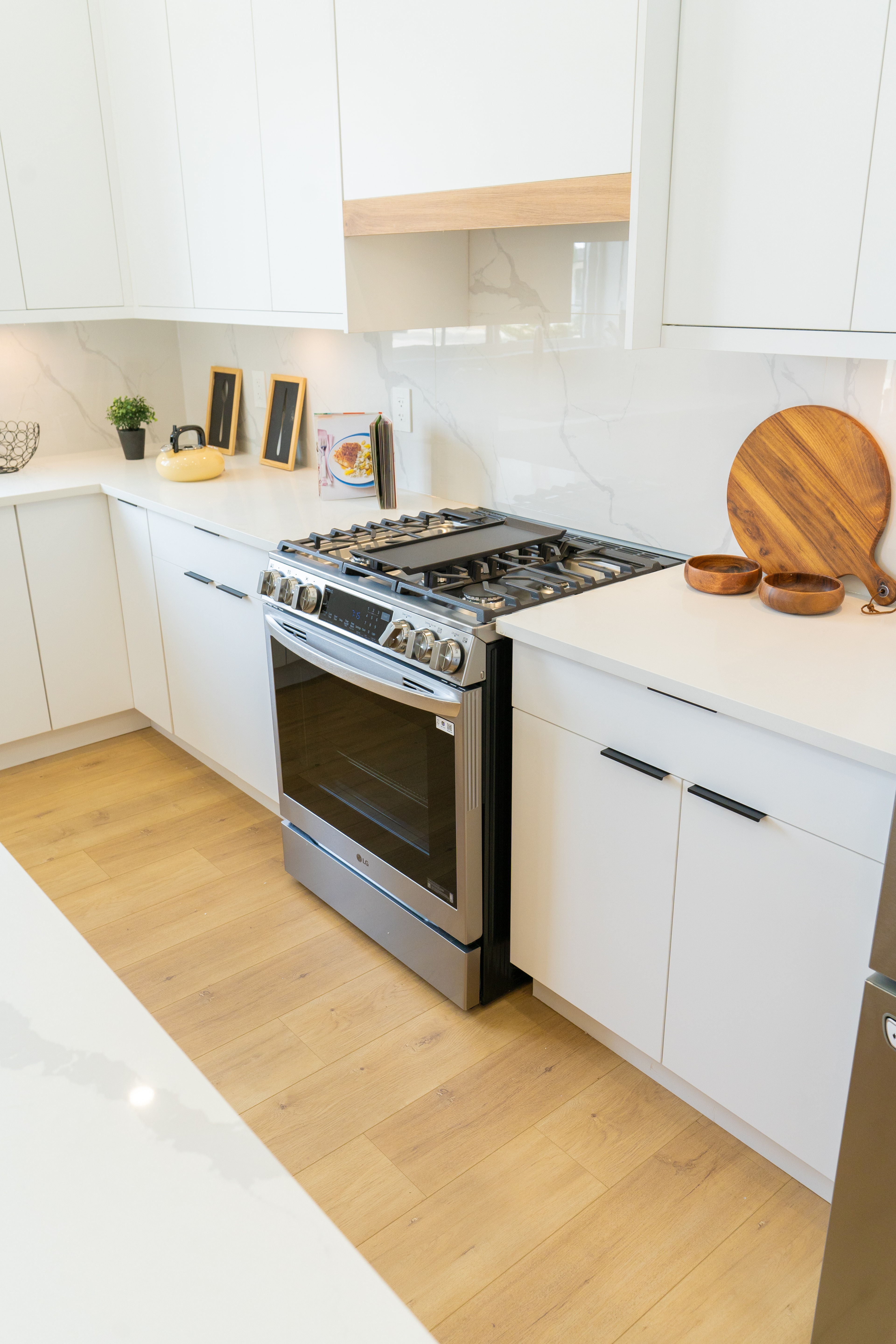 Range and cabinetry detail in the white kitchen at Willoughby Row