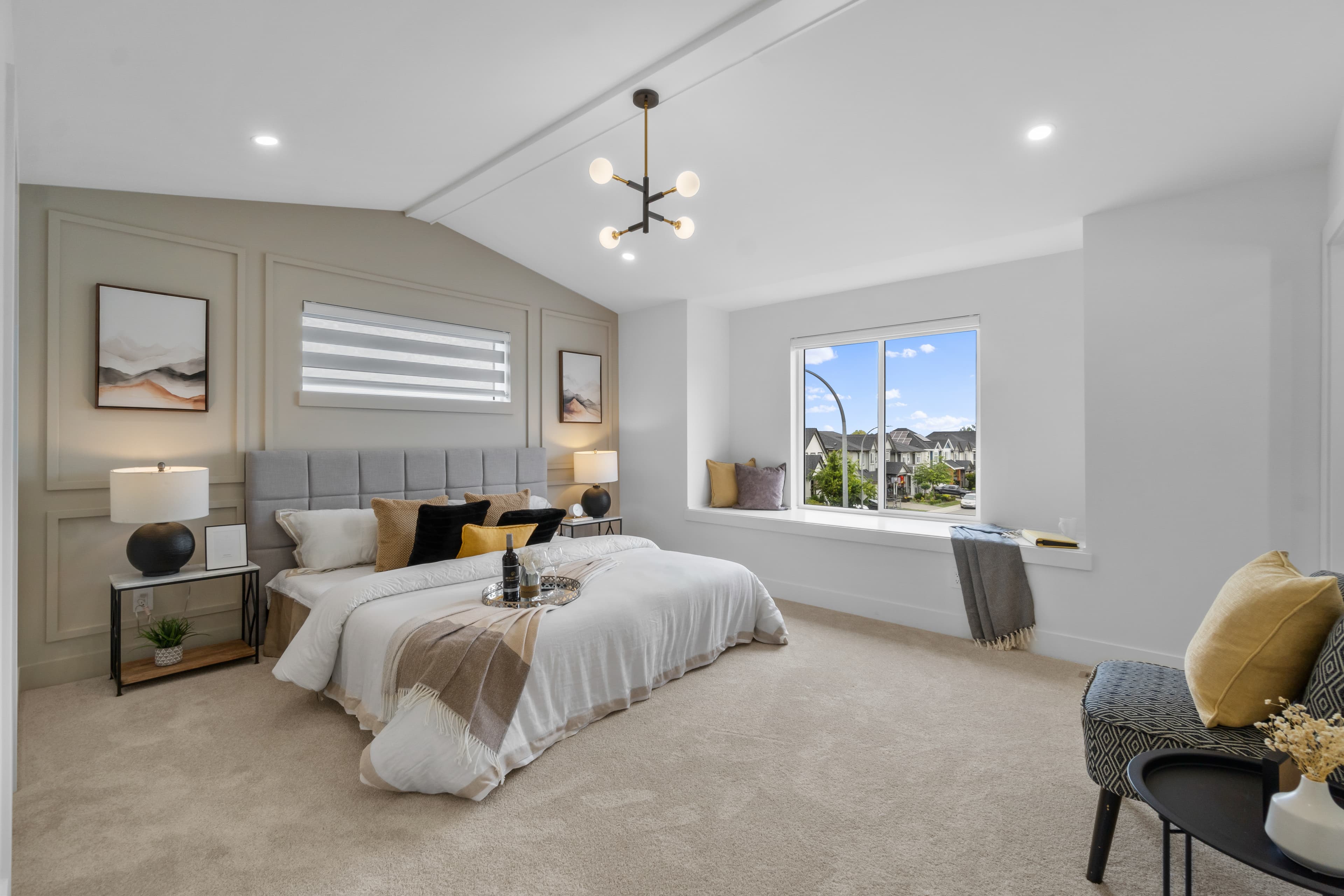 Primary bedroom at Willoughby Row with vaulted ceiling and window seat